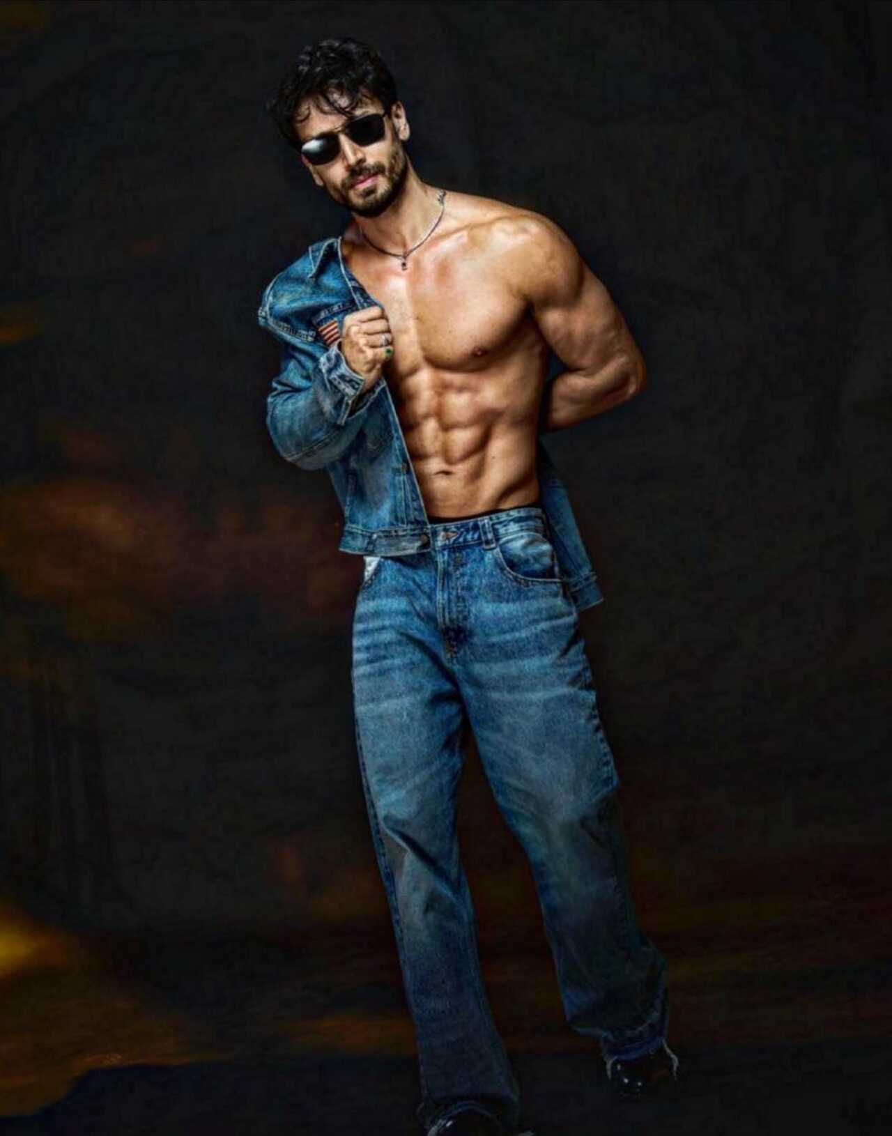 Pulling open a vintage denim jacket to reveal a sculpted torso, Tiger makes double denim look like a red-carpet statement. 